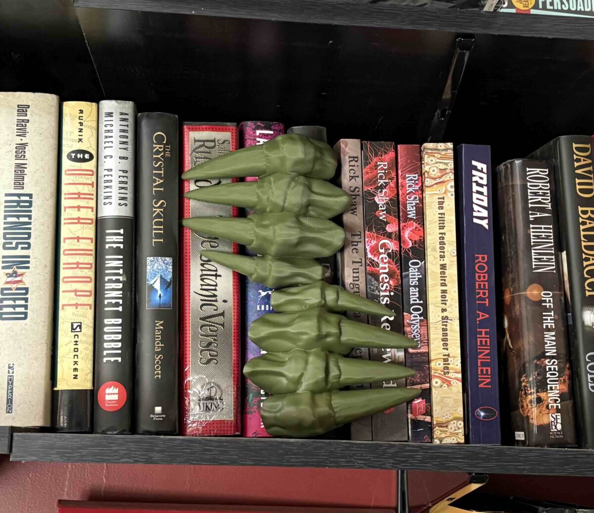 image of 3D printed demon claws in a bookshelf